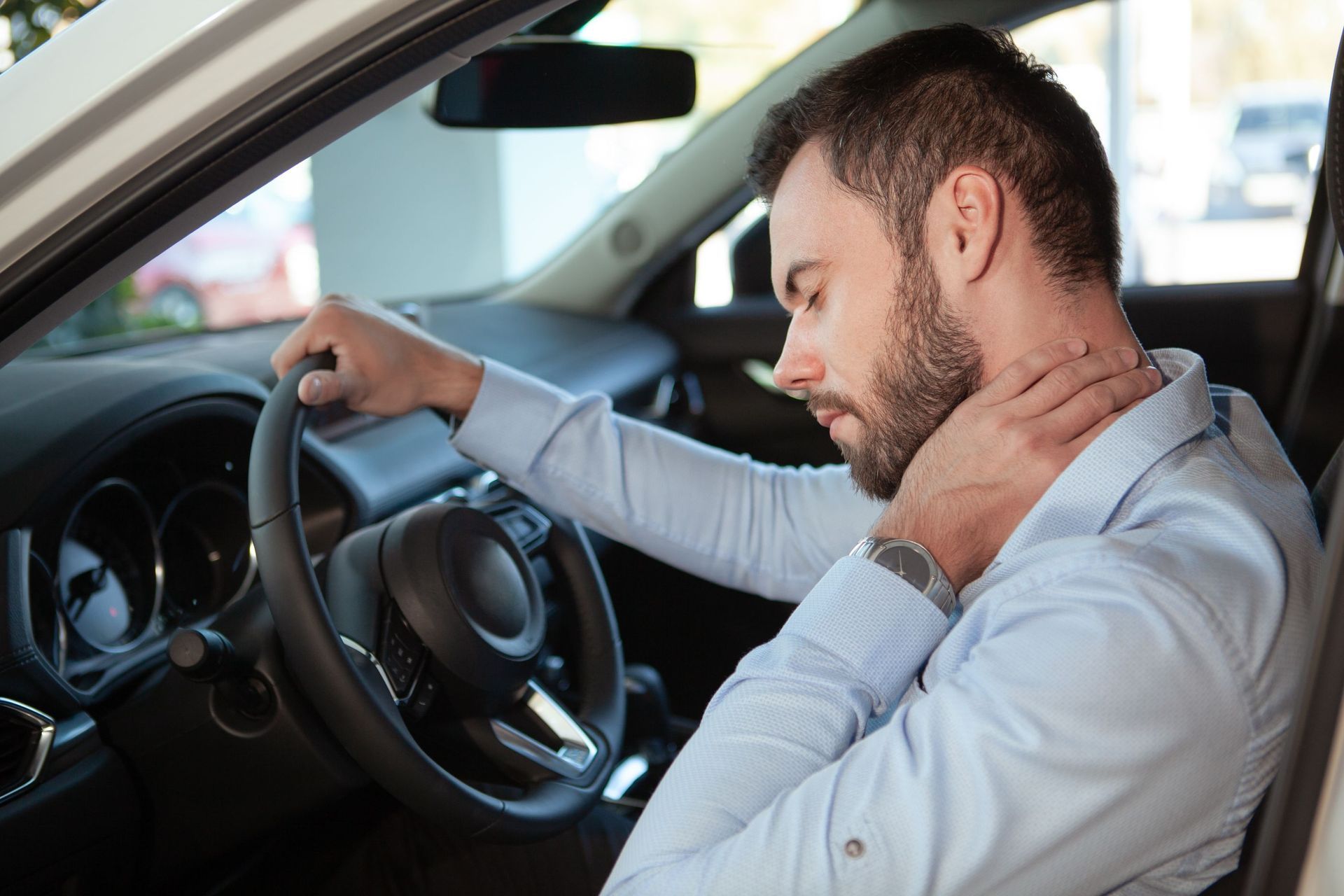 young man rubbing his aching neck