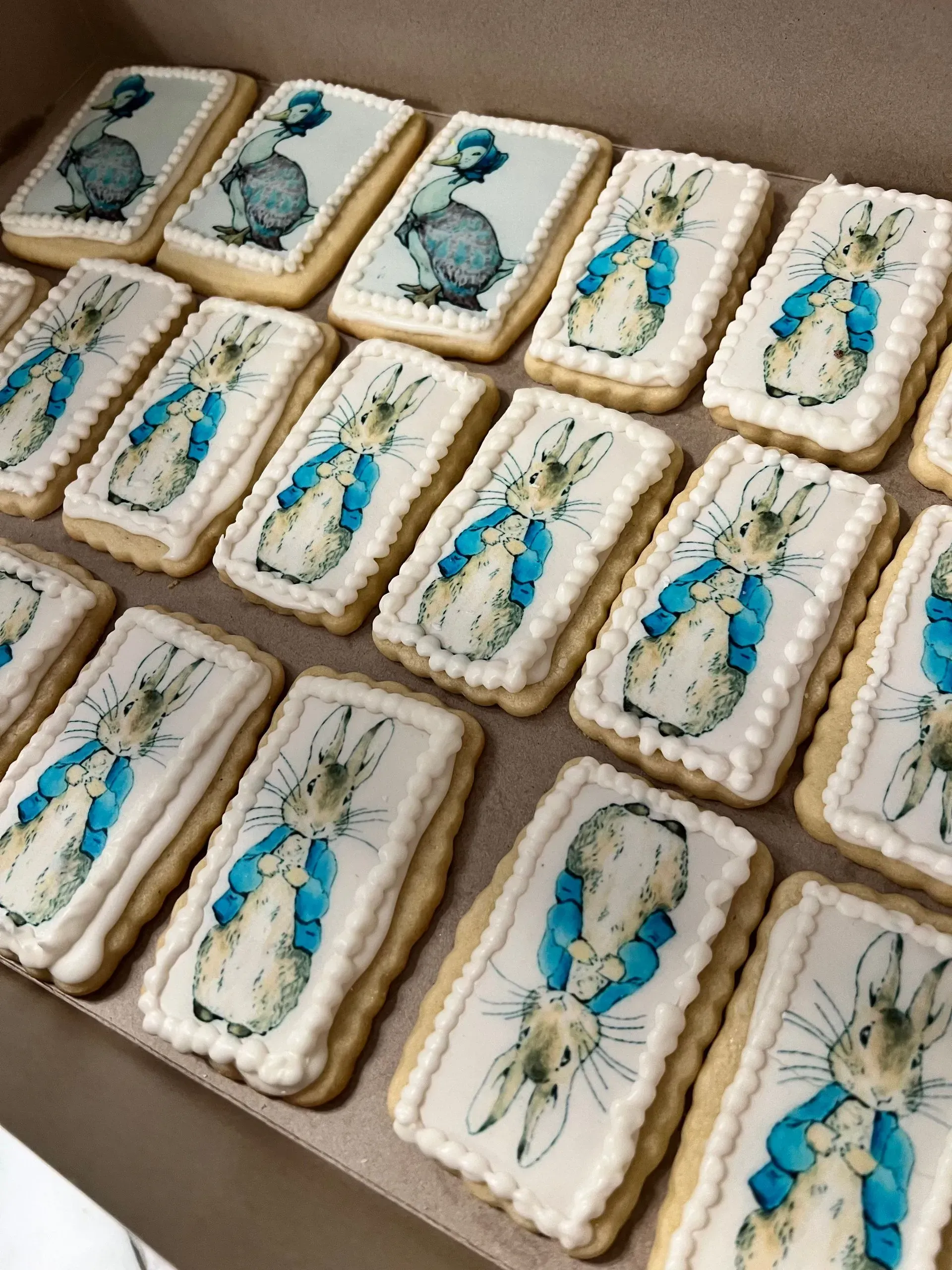 Assorted iced cookies with blue and white butterfly designs arranged on a tray