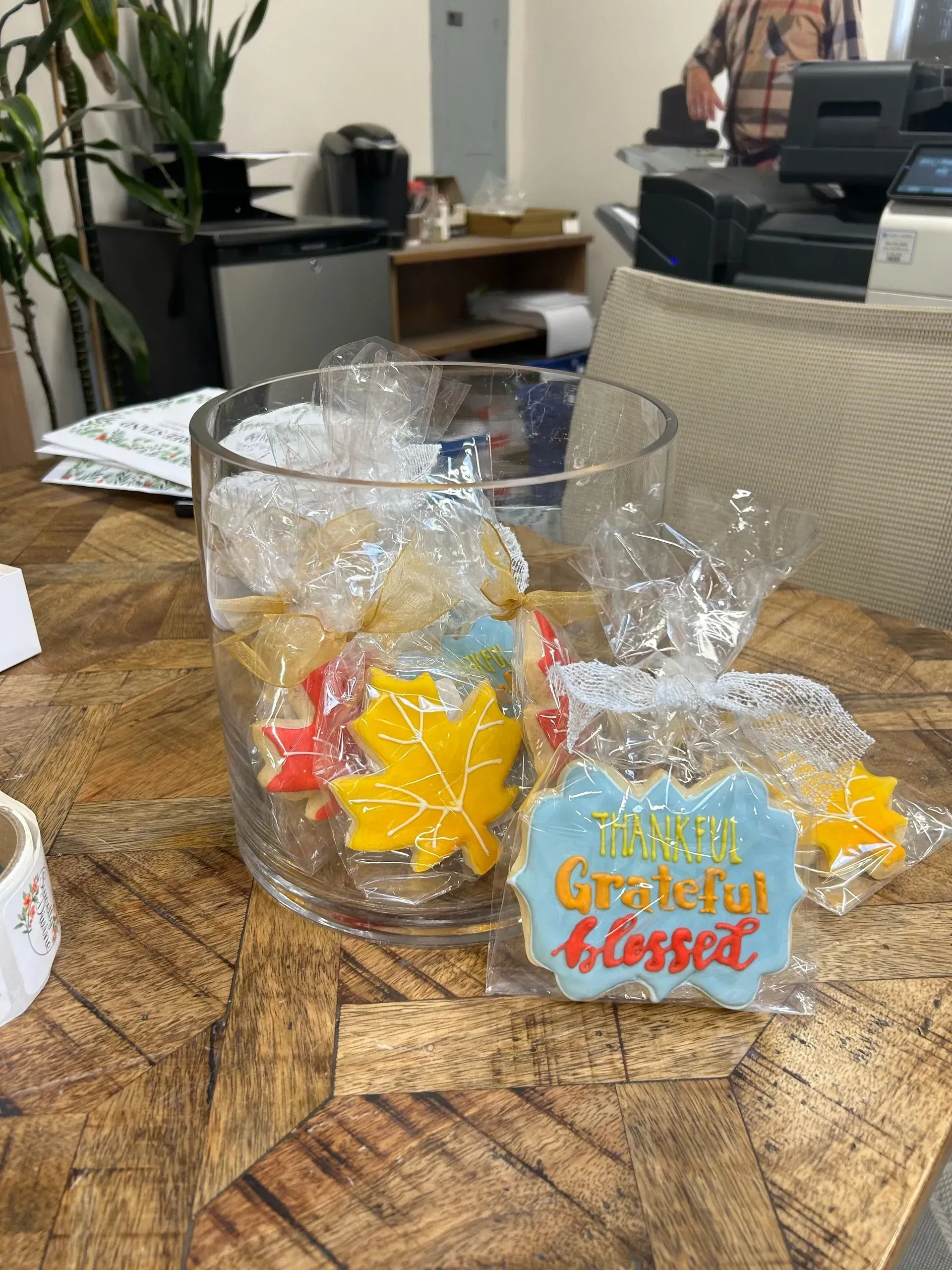 Gift basket on a wooden table with yellow star-shaped treats and “Thankful, Grateful, Blessed” tag.