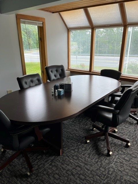 A conference room with a long table and chairs