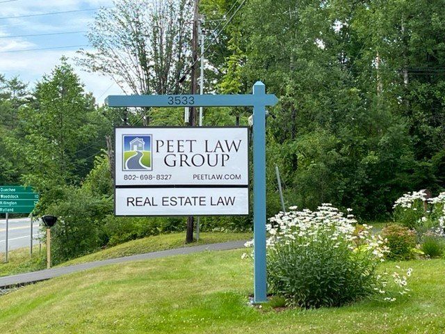 A sign for Peet Law Group Real Estate Law