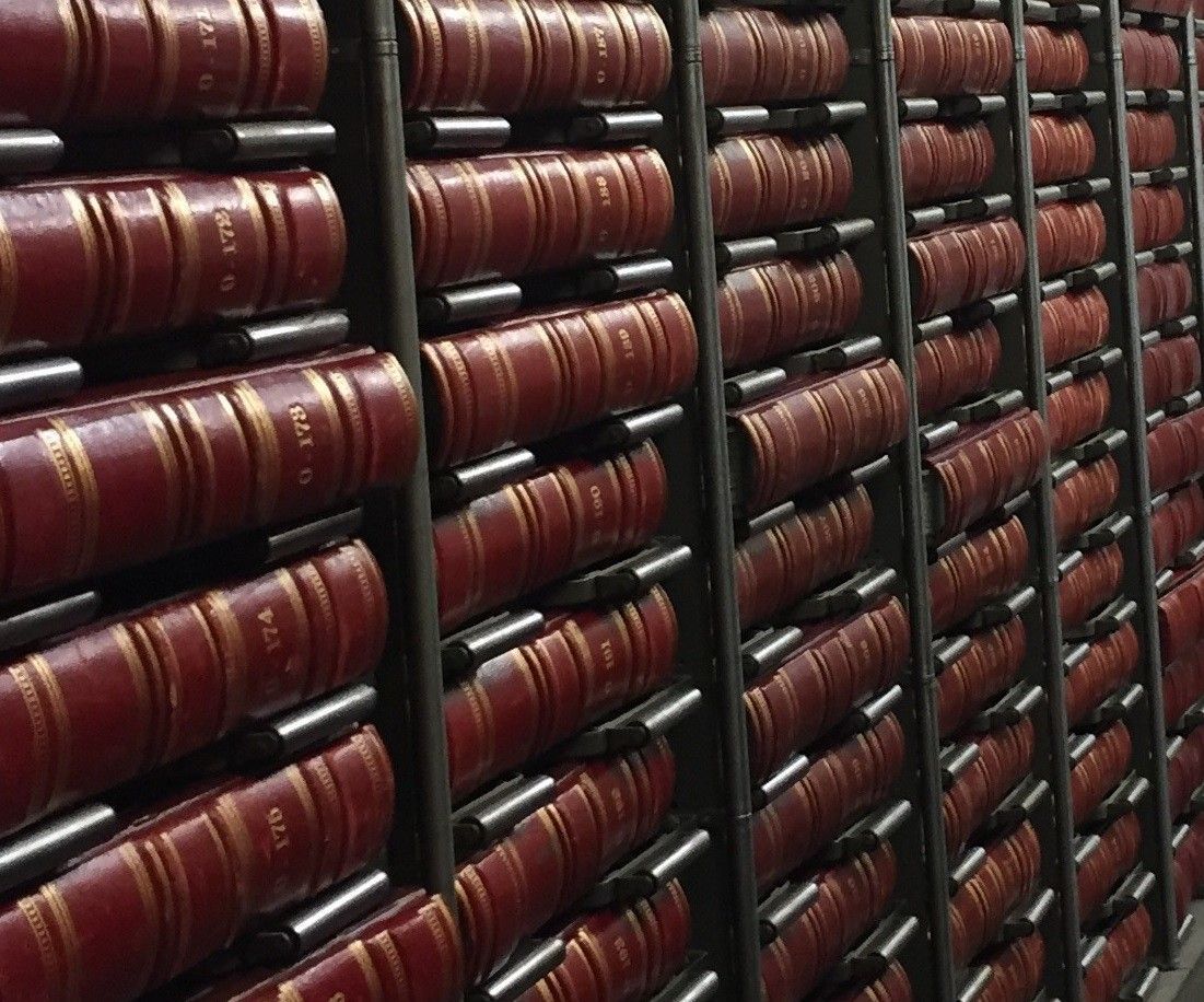 A row of shelves filled with lots of red books