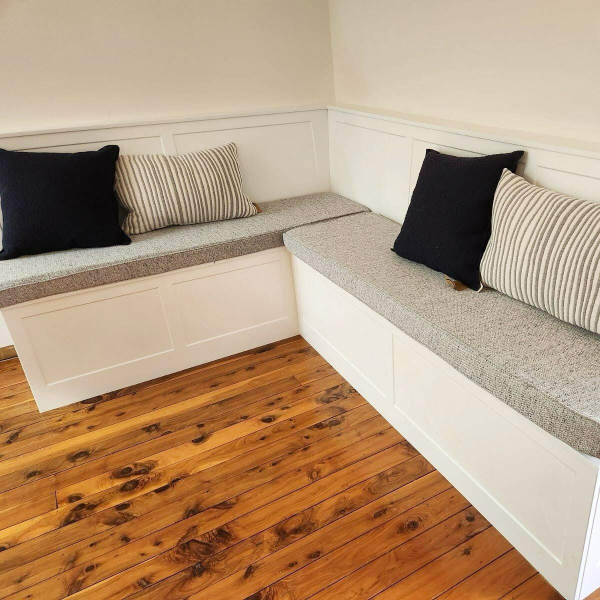 A Wooden Floor With A Couch And Pillows On It — Kreuzer Cabinets In East Wagga Wagga, NSW
