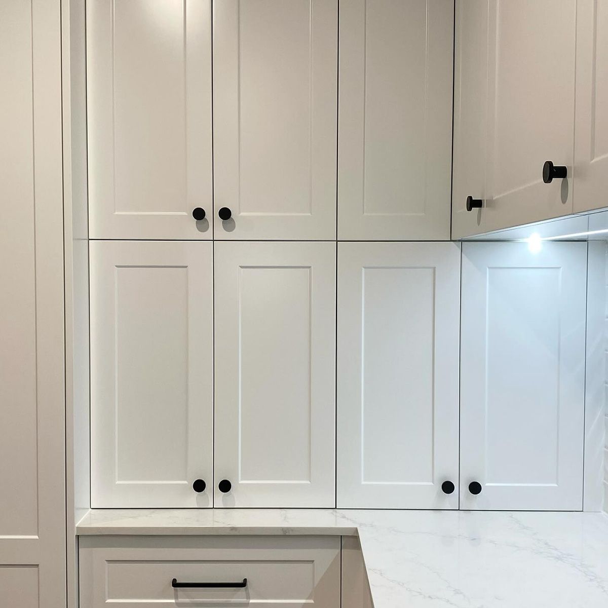 A Kitchen With White Cabinets And Black Handles And A Marble Counter Top — Kreuzer Cabinets In East Wagga Wagga, NSW