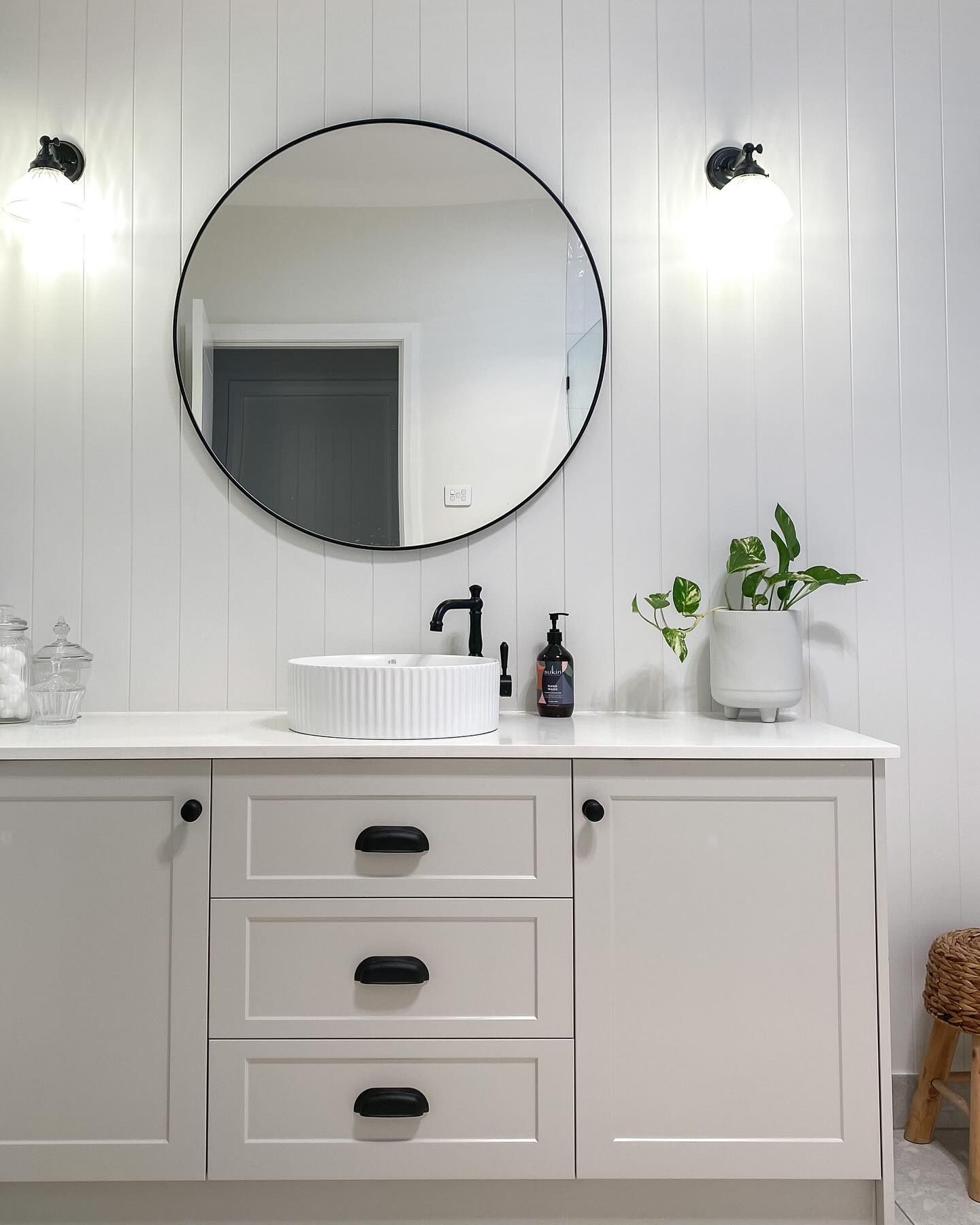 A Bathroom With White Cabinets, a Sink, and a Round Mirror — Kreuzer Cabinets In East Wagga Wagga, NSW