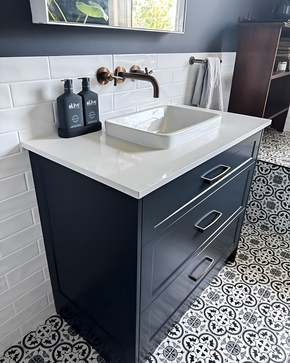 Dark Blue Kitchen with White Countertop, Rectangular Sink, and Patterned Floor