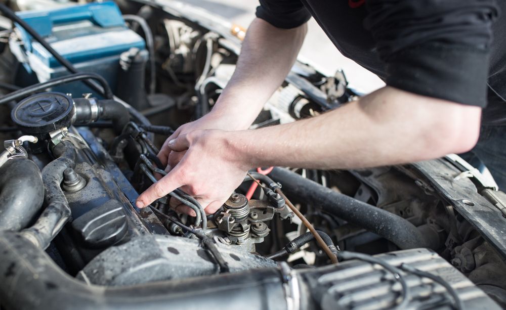 A Man is Working on the Engine of a Car — Noosa Batteries in Noosaville, QLD