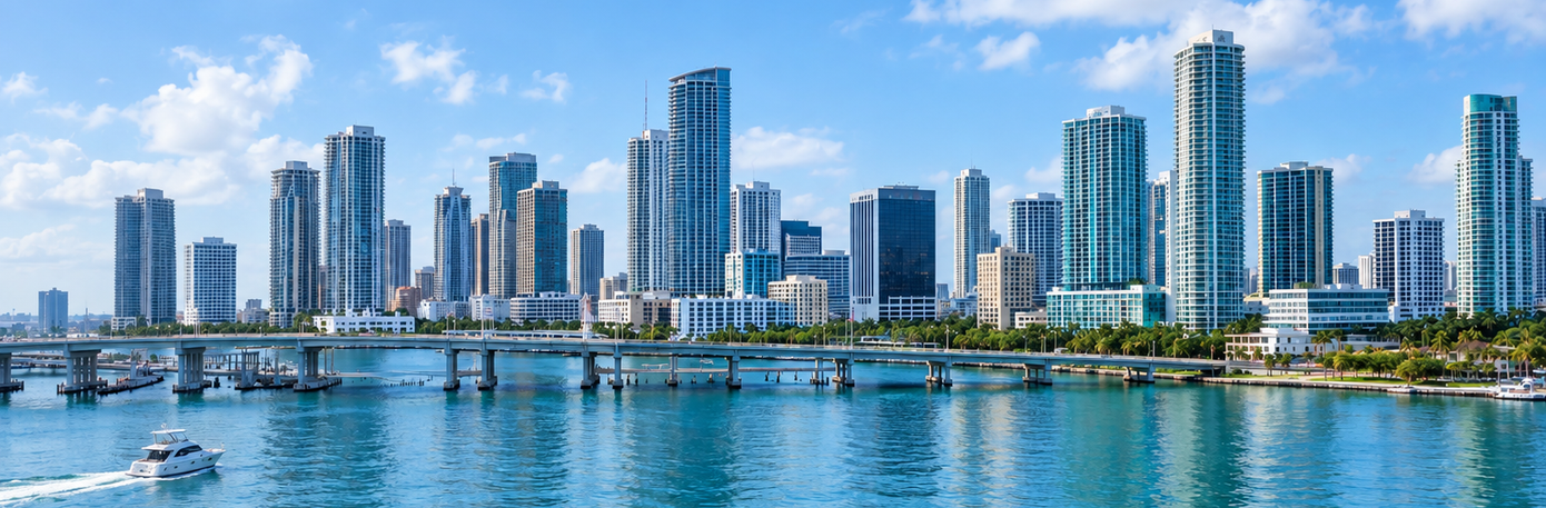 Modern waterfront skyline with high-rise buildings, bridge, and boats on calm blue water