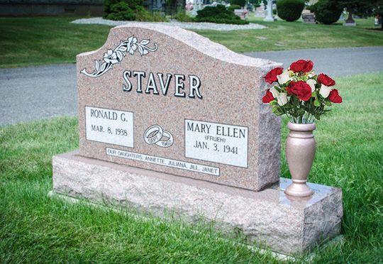 Staver family gravestone with engraved names and a vase of red flowers on a grassy lawn