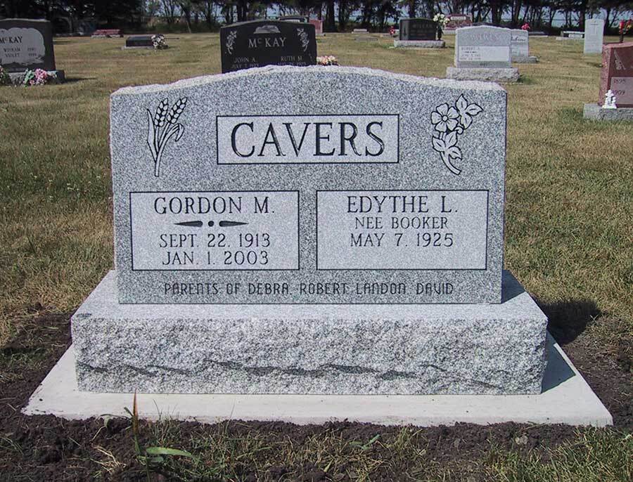 CAVERS gravestone in a cemetery with engraved names, dates, and a floral design
