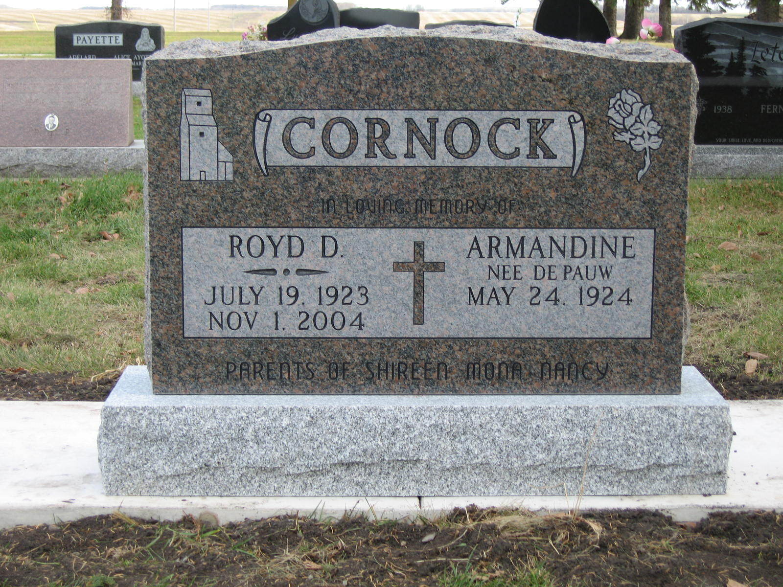 CORNOCK gravestone with engraved names and dates, set in a cemetery