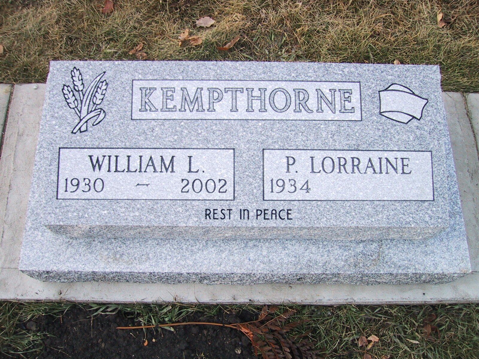 Gray gravestone engraved “KEMPTHORNE” with names William L. and P. Lorraine, resting in peace.