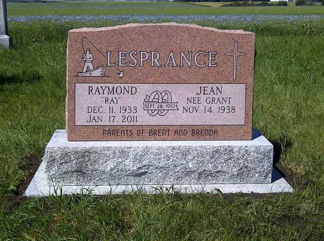 Brown gravestone in a grassy cemetery with the name LESPRANCE engraved on top.