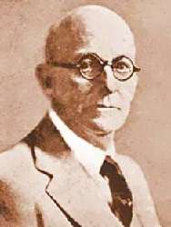 Portrait of a bald man wearing glasses, suit, and tie; sepia-toned photo.