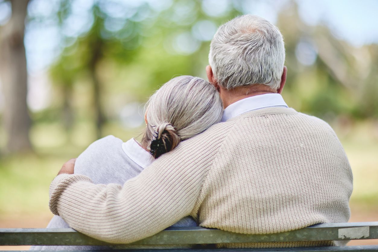 Elderly Couple Hugging, Sitting on a bench