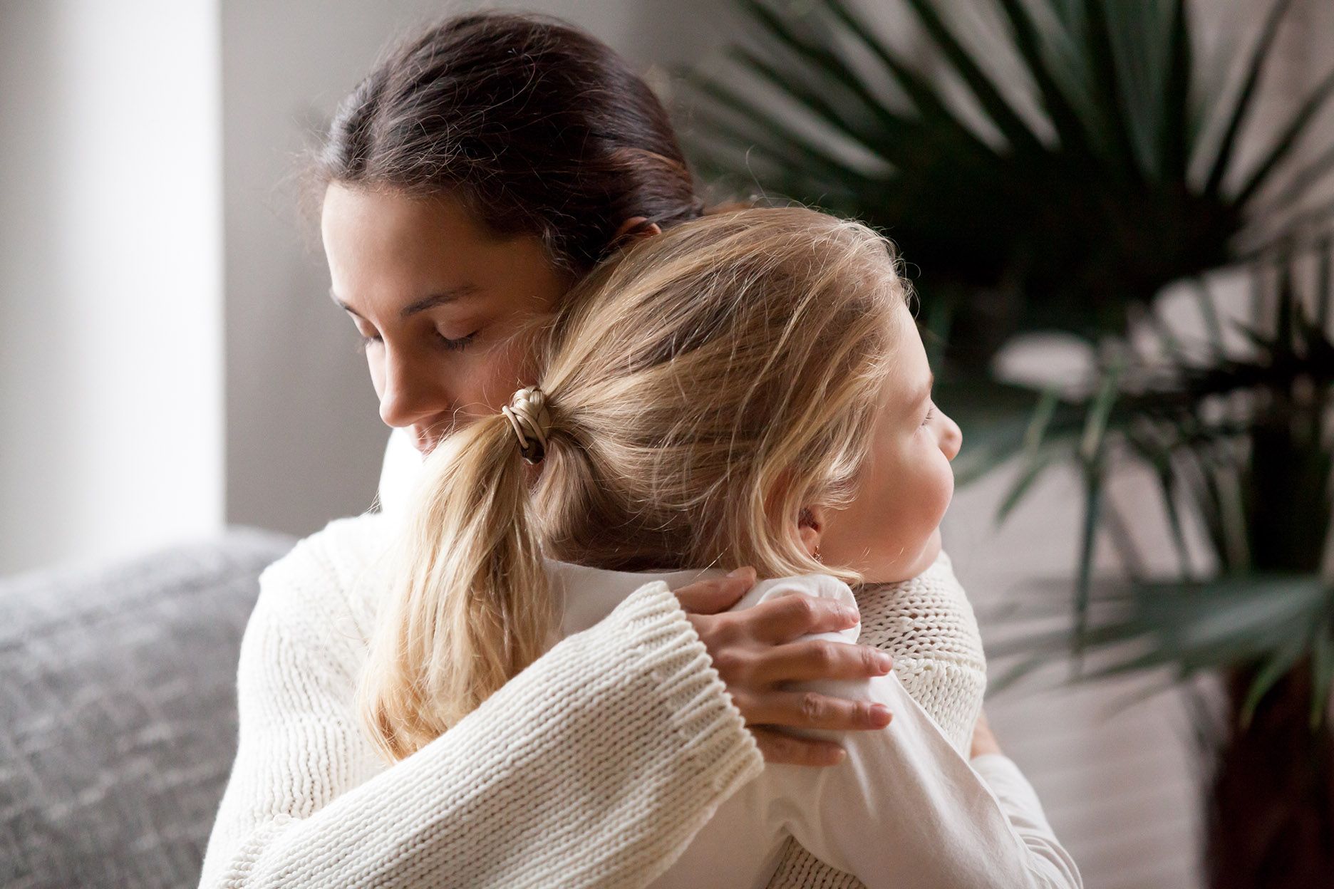 loving mother hugging cute little girl