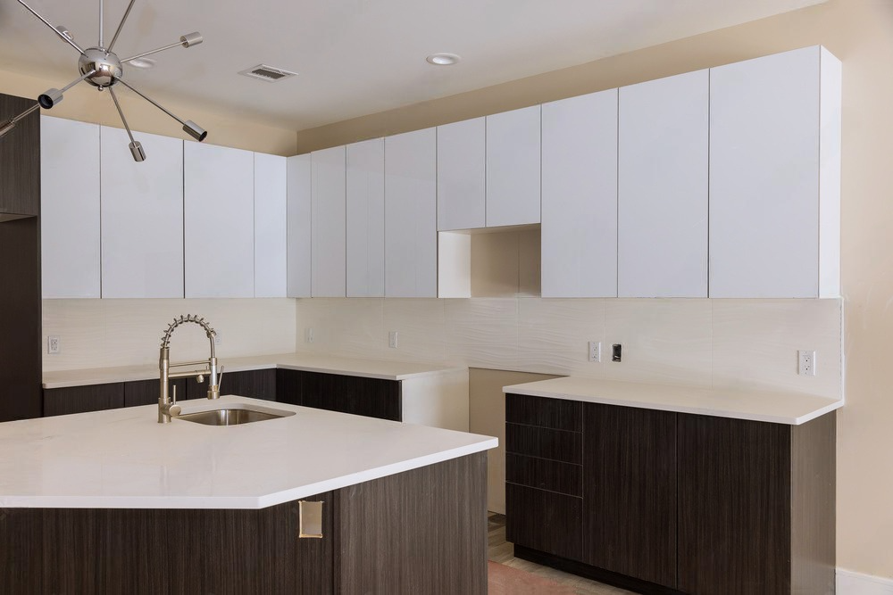 A kitchen with a large island and a sink.