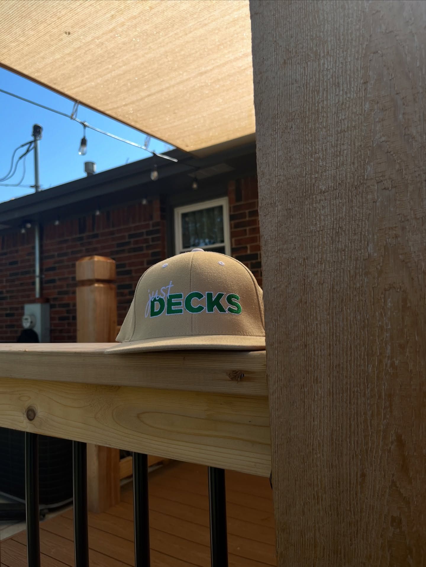 A tan hat with the green text