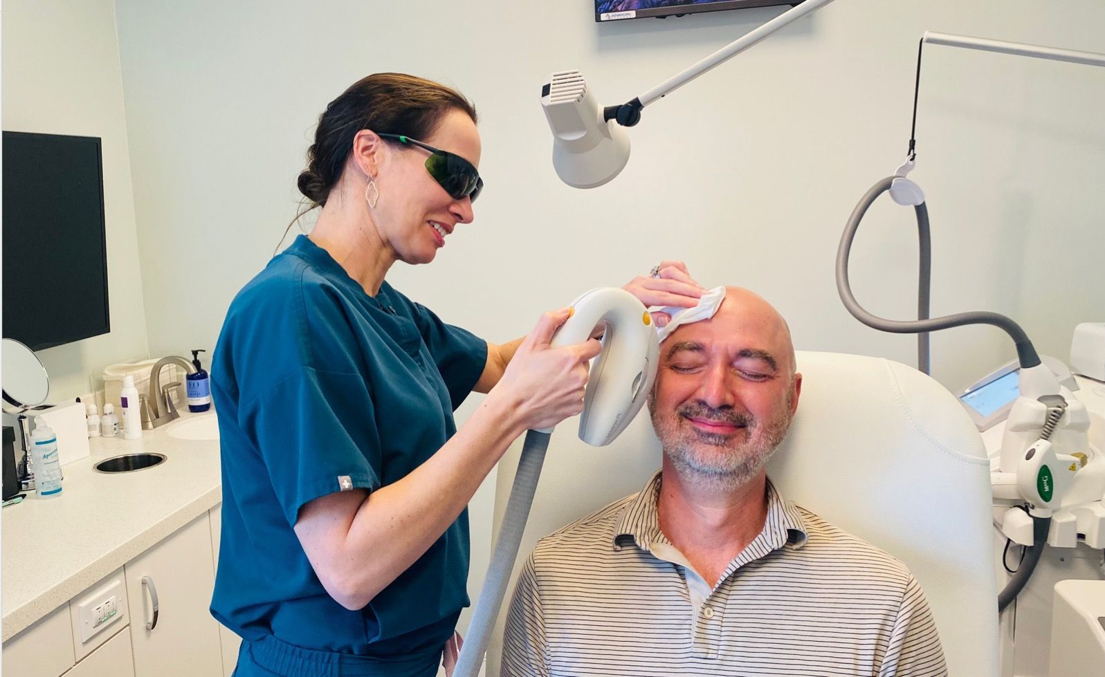 Dr. McGee using IPL to treat Rosacea on a male patient