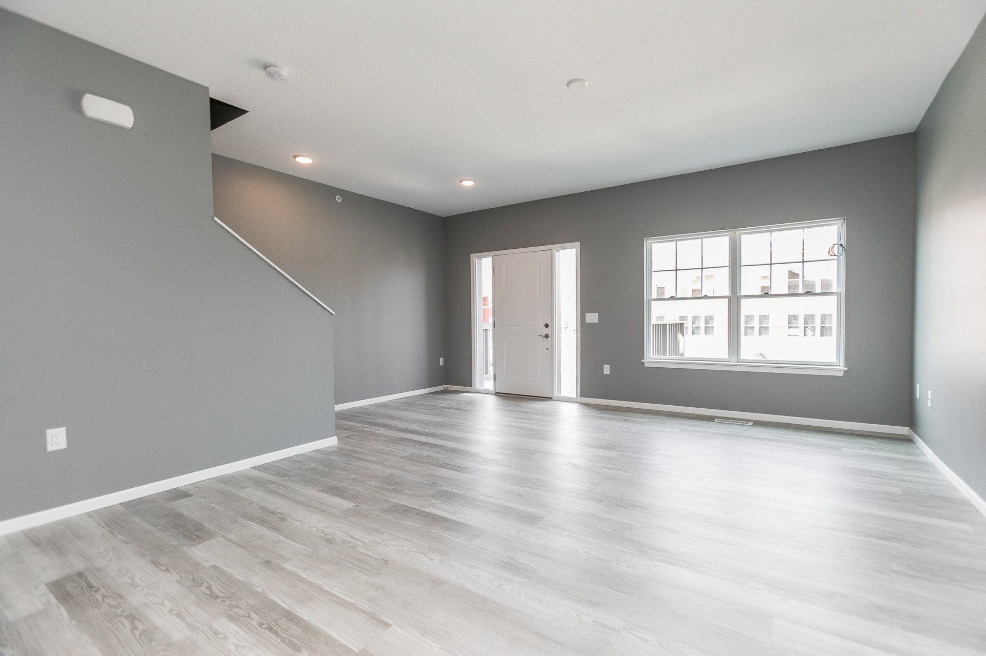 Interior of downstairs with large windows and front door