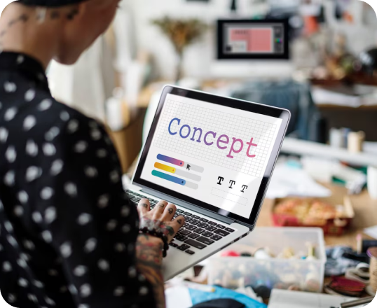 A woman is using a laptop computer with the word concept on the screen.