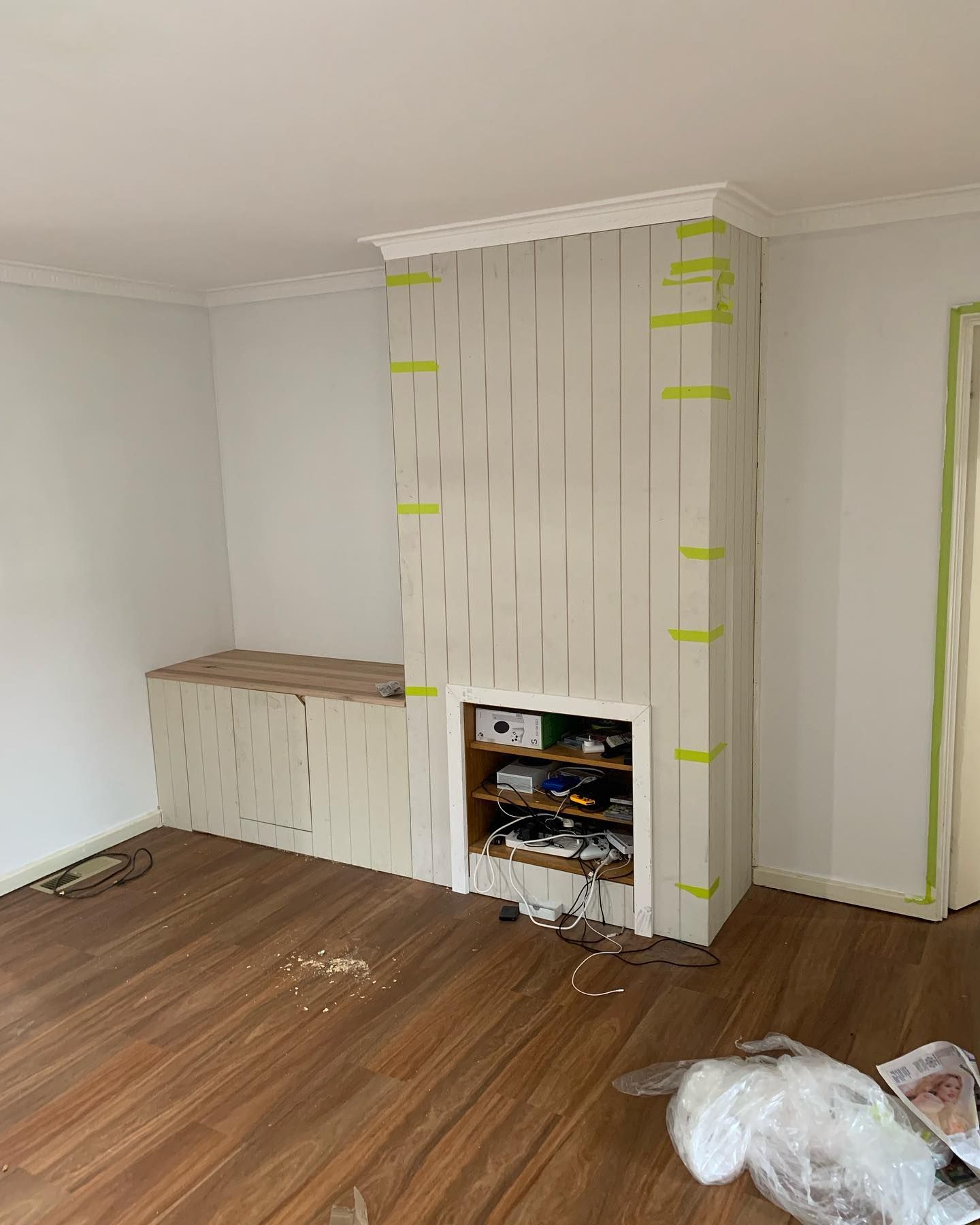 A Living Room With A Fireplace And A Dog Laying On The Floor — Renovo Contractors In Monash, ACT
