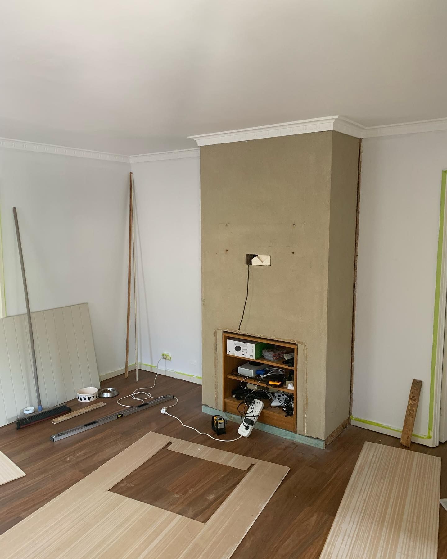 A Living Room With Hardwood Floors And A Fireplace — Renovo Contractors In Monash, ACT