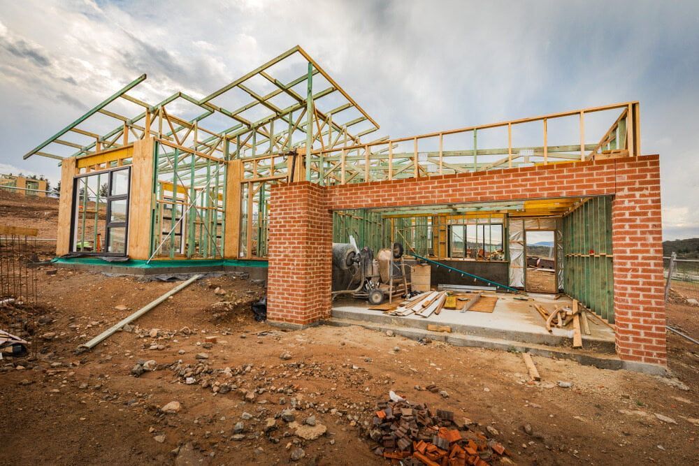 A House Is Being Built In The Middle Of A Dirt Field — Renovo Contractors In Monash, ACT