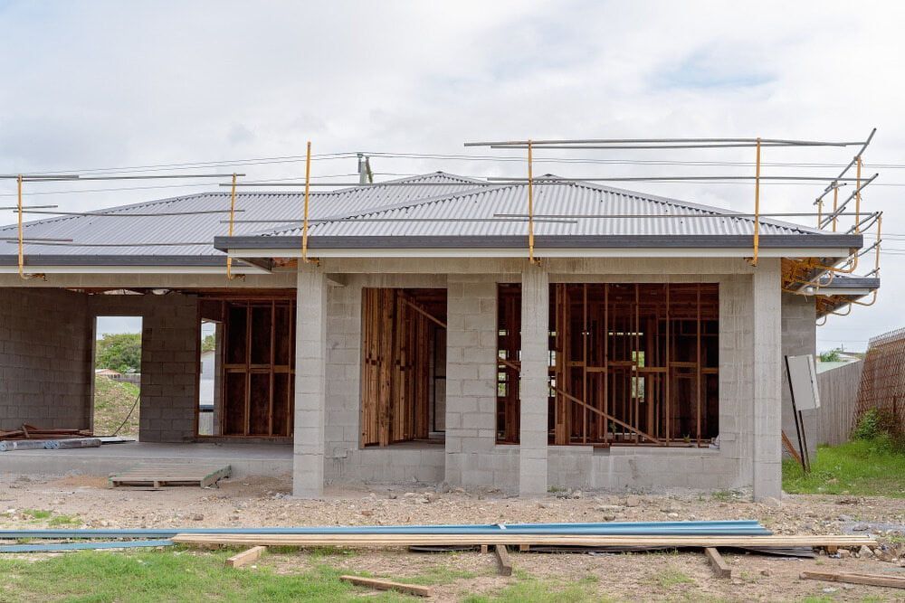 A house is being built in the middle of a field.