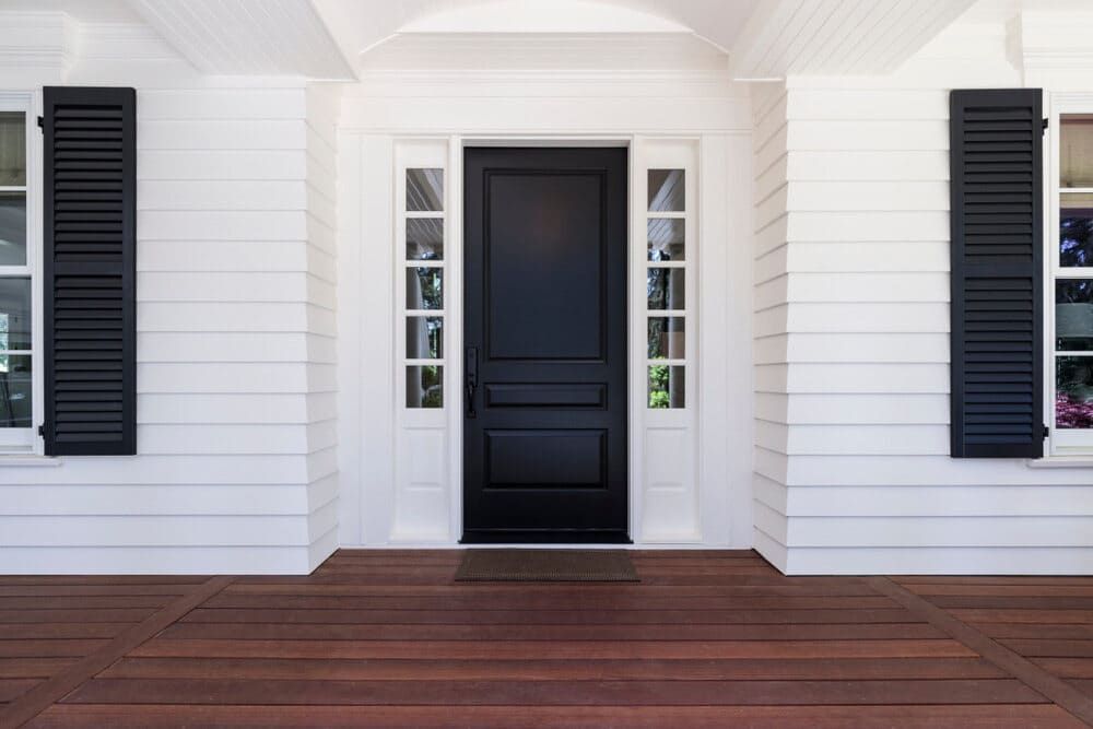 A White House With A Black Door And Black Shutters — Renovo Contractors In Monash, ACT