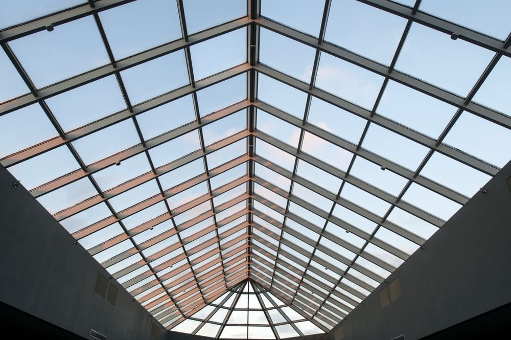 Looking Up At A Skylight With A Blue Sky In The Background — Renovo Contractors In Monash, ACT