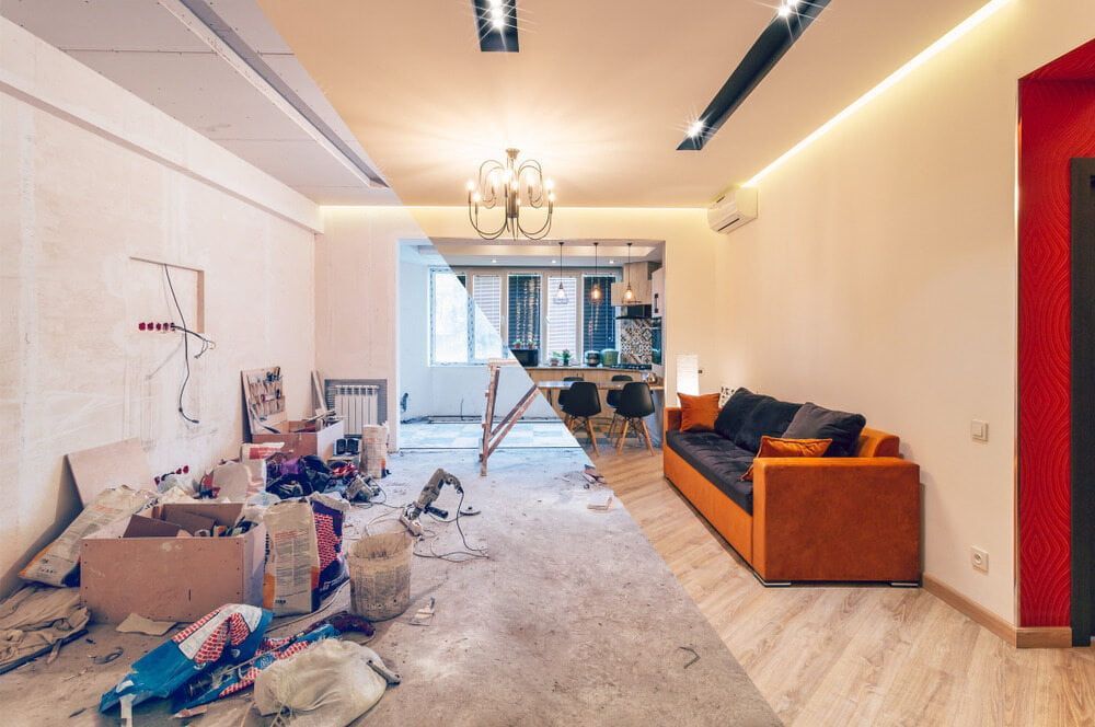 A Living Room Under Construction With A Couch And Boxes On The Floor — Renovo Contractors In Monash, ACT
