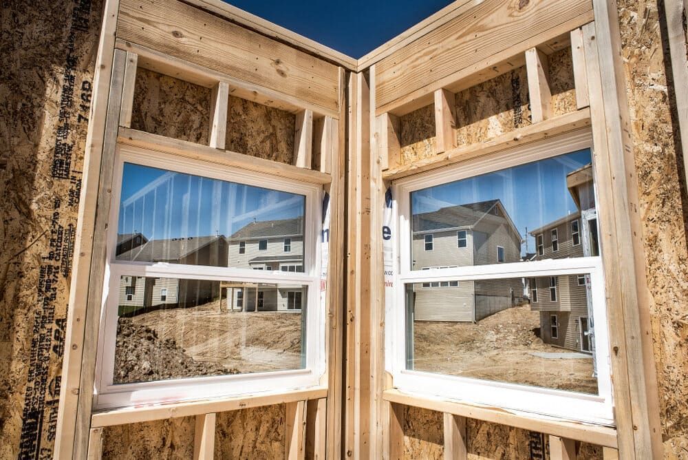 A House Is Being Built With A Lot Of Windows — Renovo Contractors In Monash, ACT