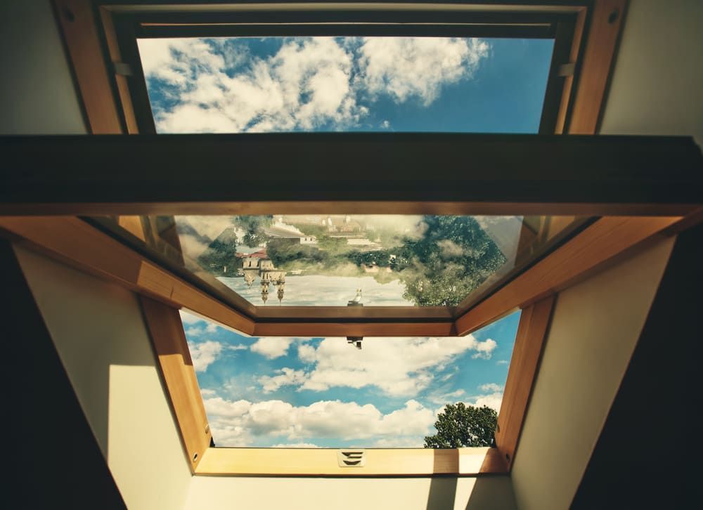 Looking Out Of A Skylight At The Sky And Clouds — Renovo Contractors In Monash, ACT