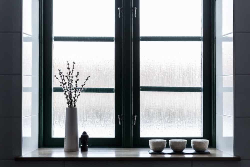 A Window Sill With A Vase Of Flowers And Three Bowls On It — Renovo Contractors In Monash, ACT