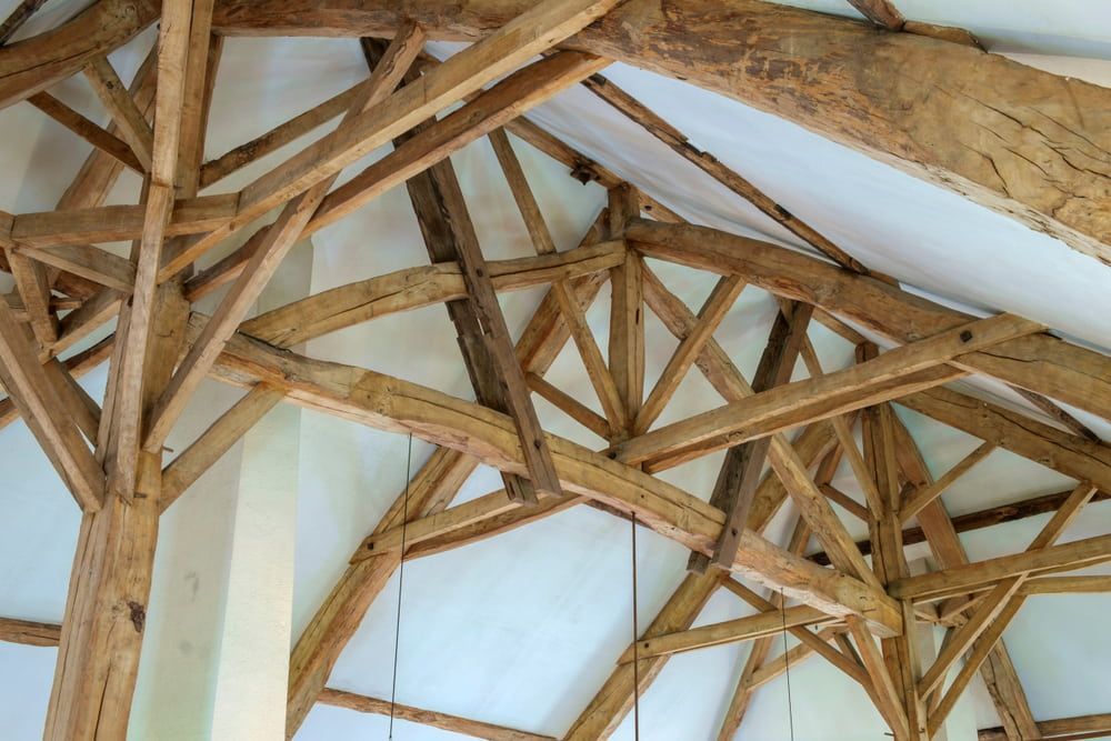 The Ceiling Of A Building Is Made Of Wooden Beams — Renovo Contractors In Monash, ACT