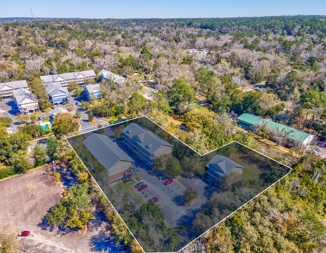 An aerial view of a residential area with a lot of trees and buildings.