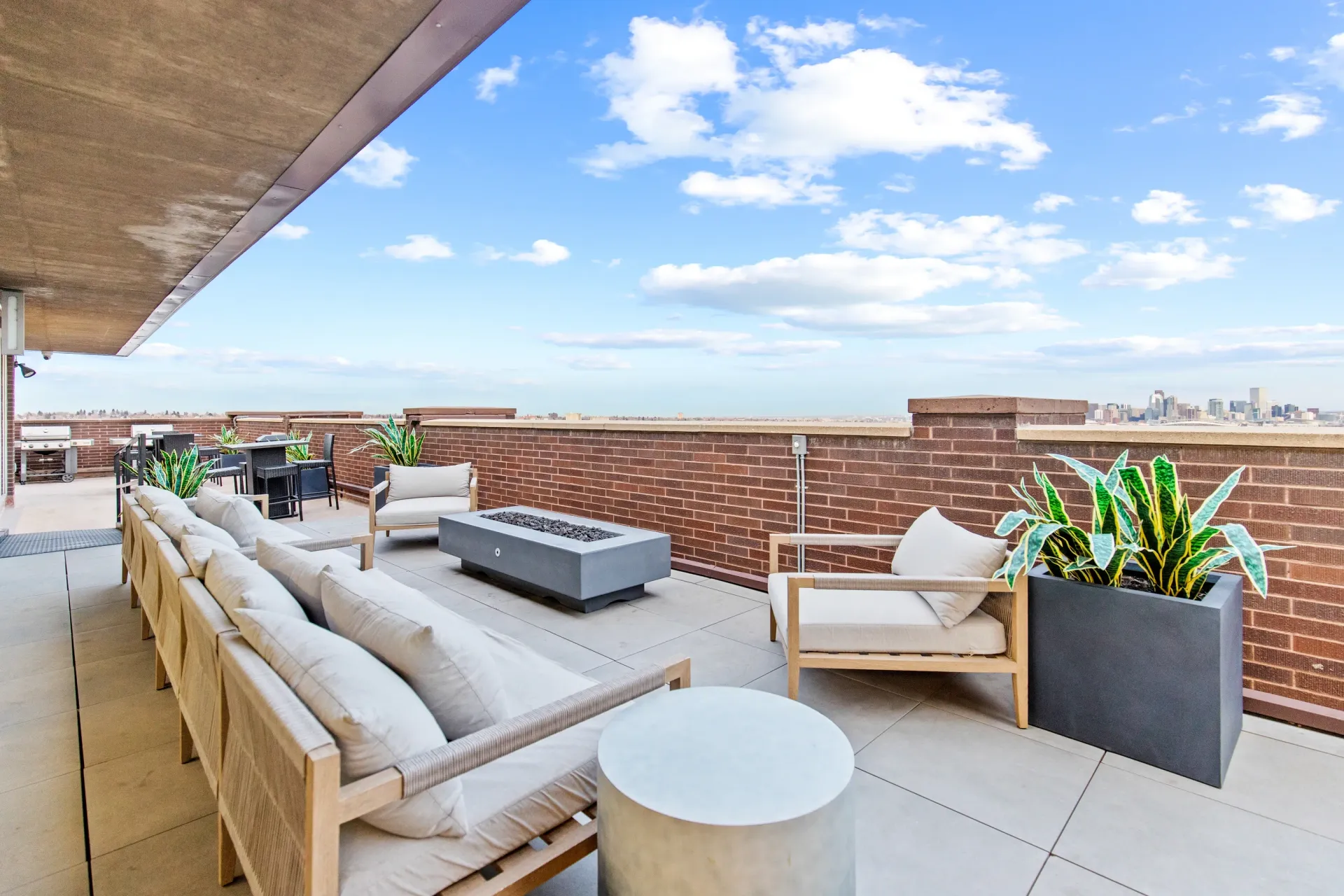 Rooftop lounge area with seating and city views.