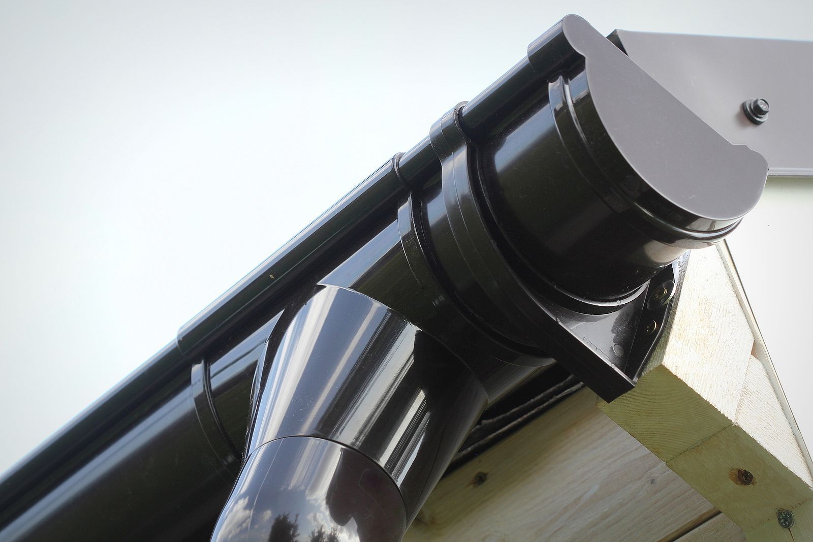 A close up of a black gutter on a roof
