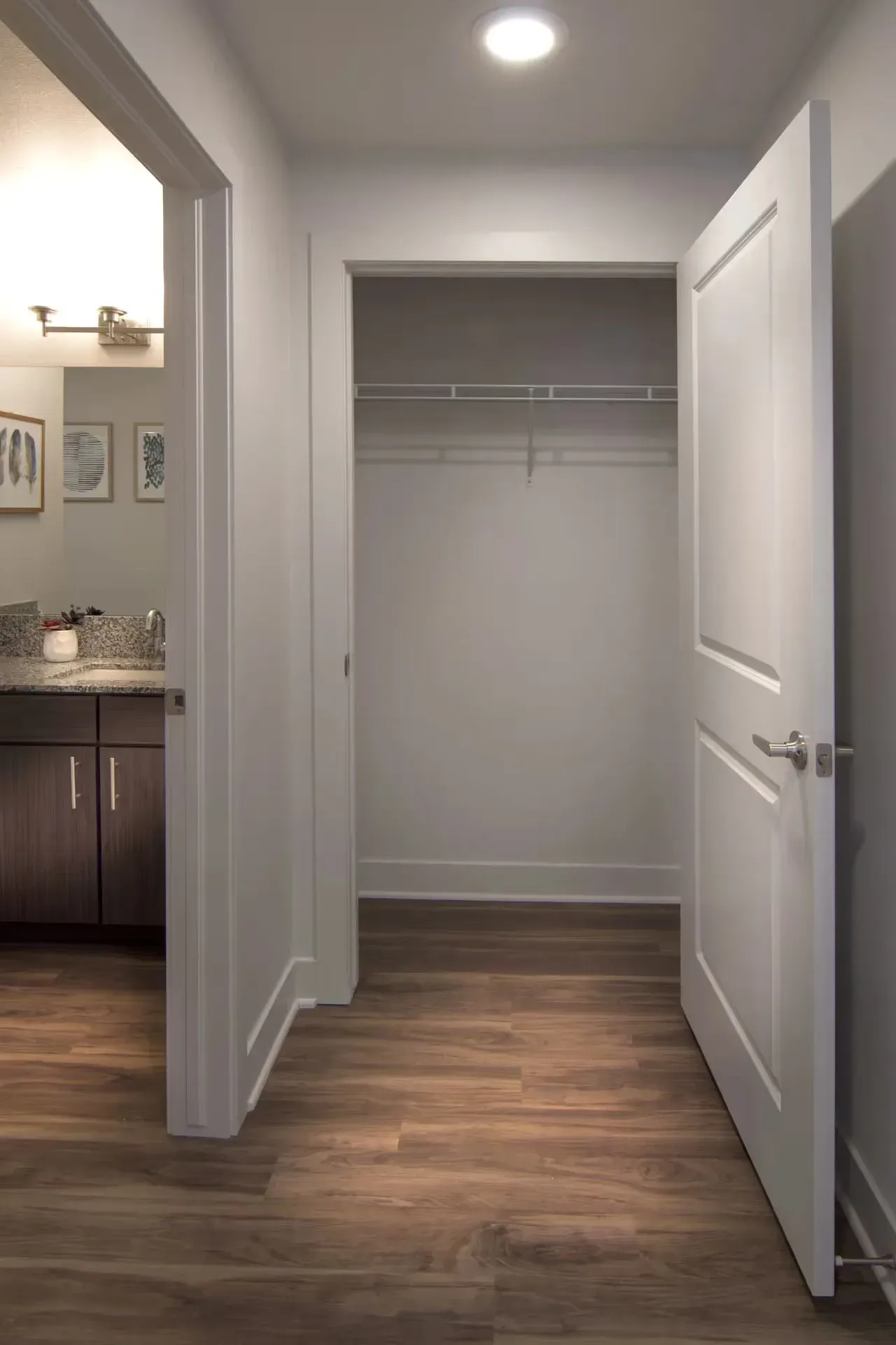 Hallway leading to a bathroom and a closet.