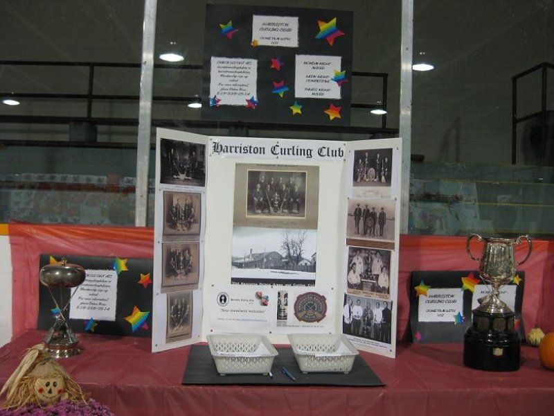 A table with trophies and a poster that says burrston carling club