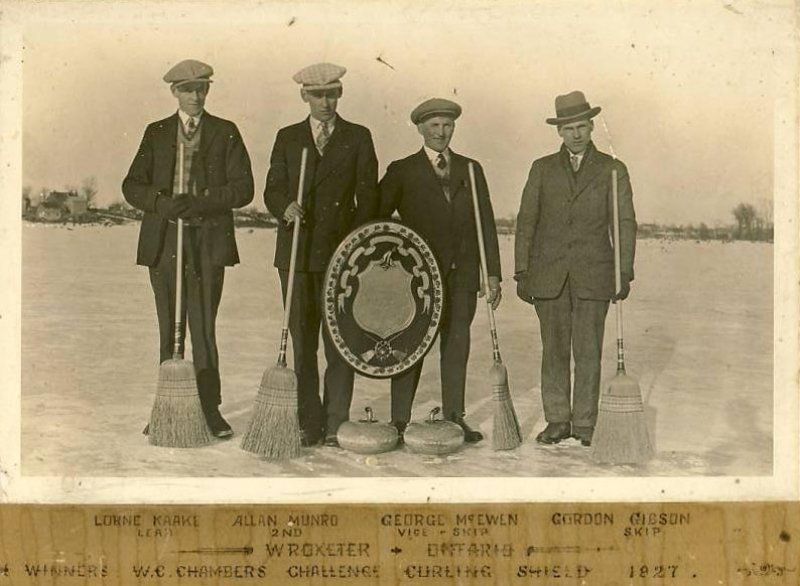 A black and white photo of four men standing next to each other