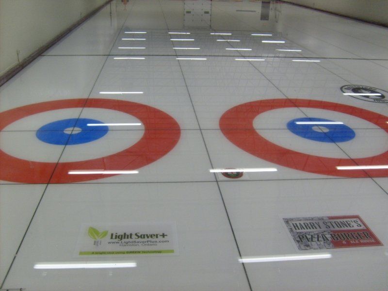 A curling rink with a sign that says light saver on it