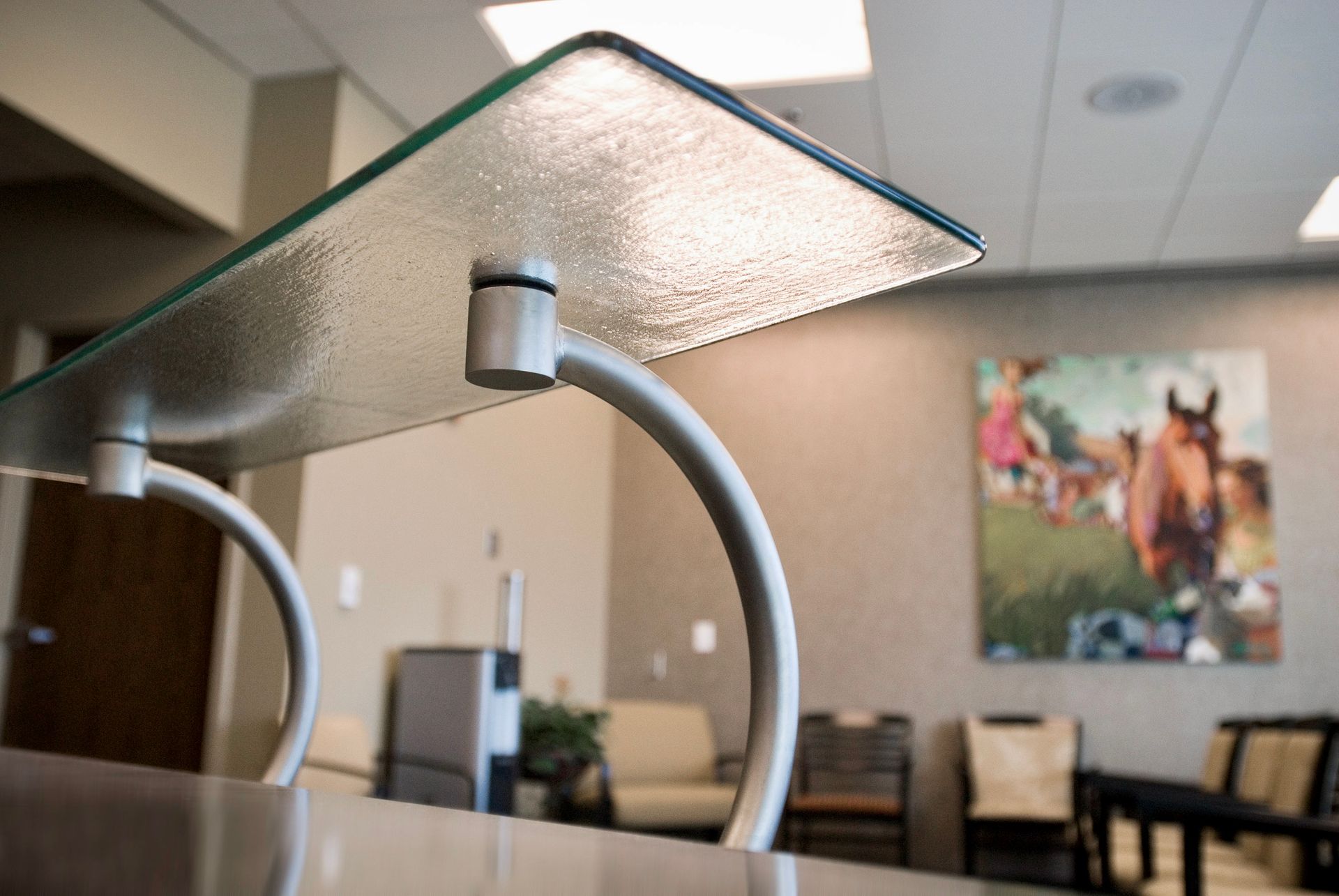 A waiting room with a picture of a horse on the wall