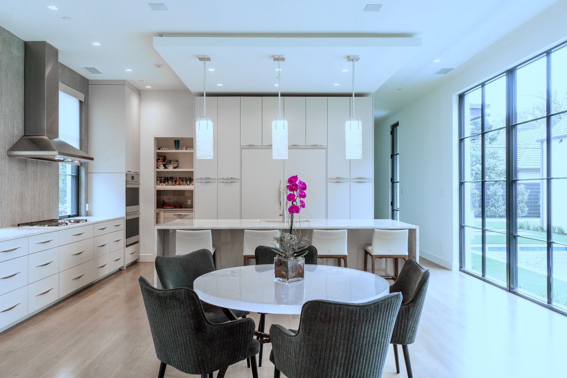 A kitchen with a round table and chairs in it