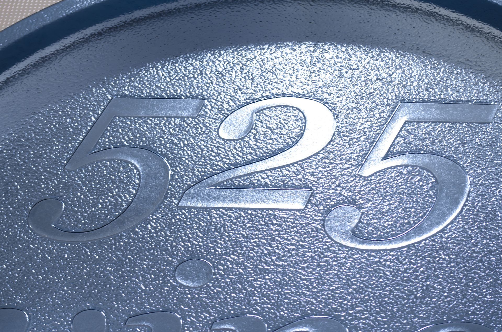 Blue textured surface with embossed number 525.