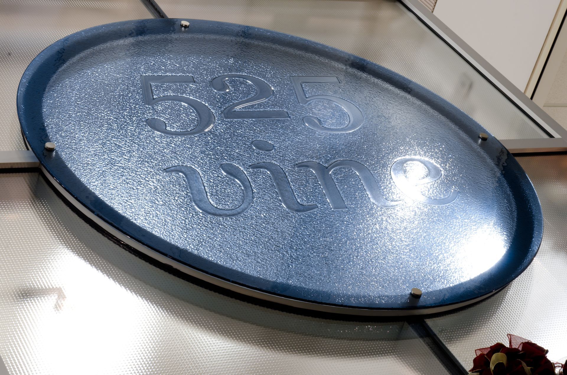 Blue oval sign reading “52” mounted on a metal frame