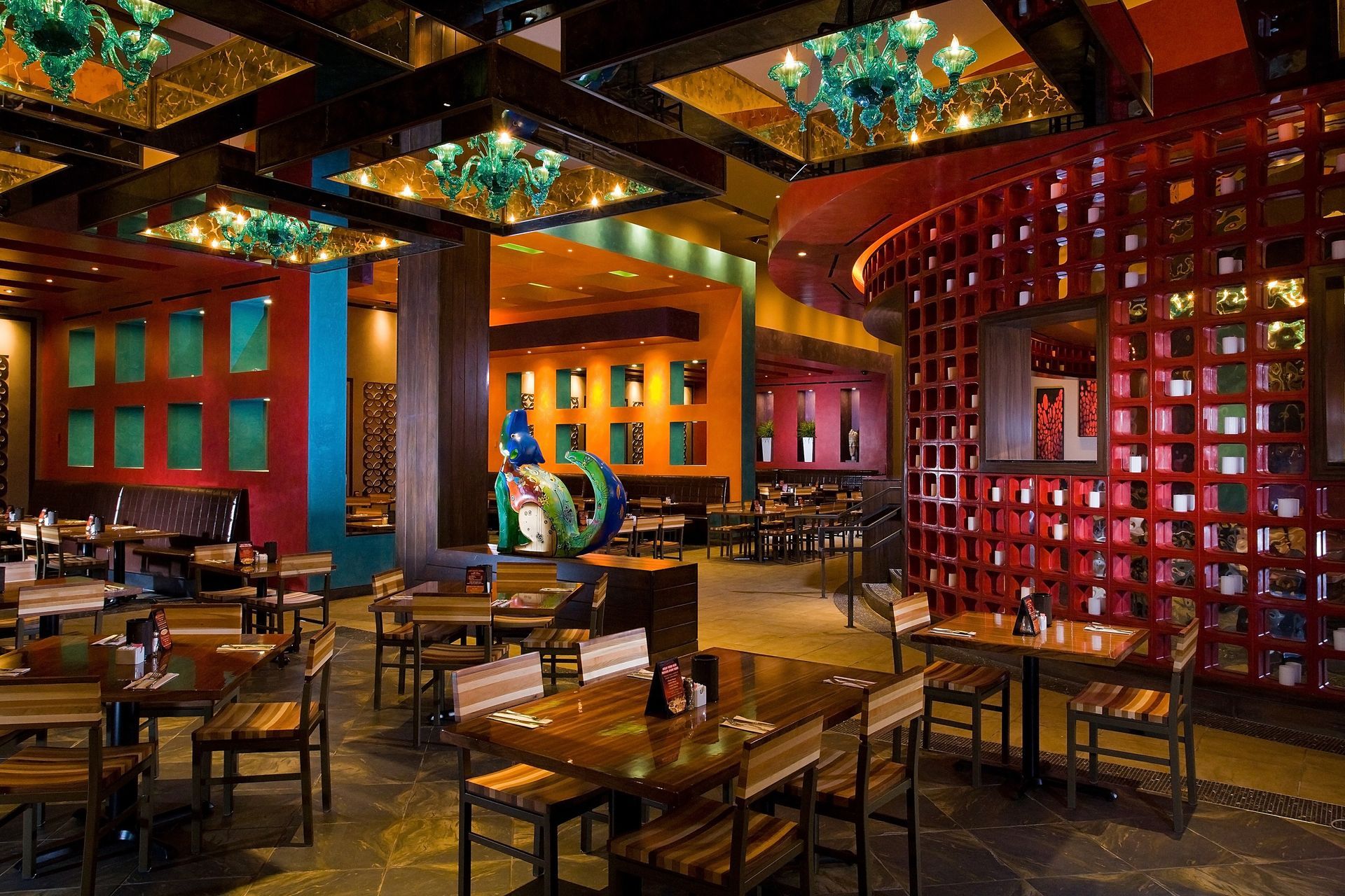 A restaurant with many tables and chairs in it