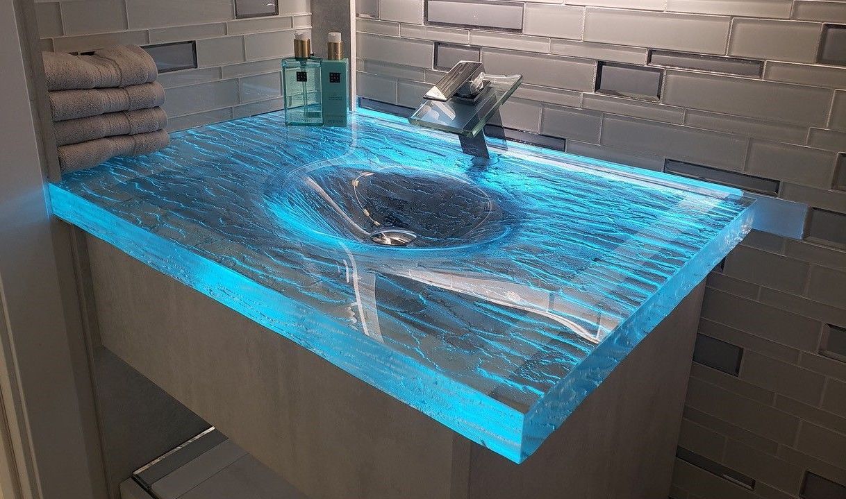 A glass sink backlit with blue LED lights. A glass sink backlit with blue LED lights.