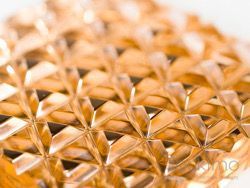 Close-up of a shimmering gold geometric lattice pattern